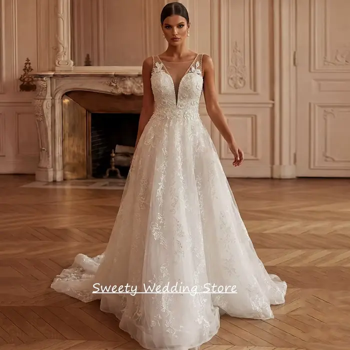 Robe de mariée charmante personnalisée sans manches, col en V profond, ornée de perles et de dentell