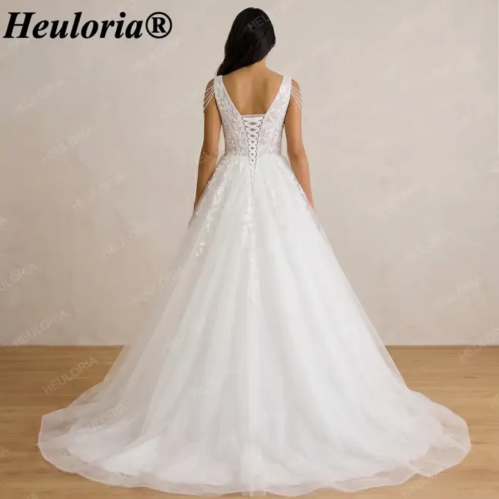 Robe de mariée élégante Heuloria à col en V profond avec appliques en dentelle, épaules à franges de perles, robe de mariée en tulle coupe A-line avec effet illusion, Co