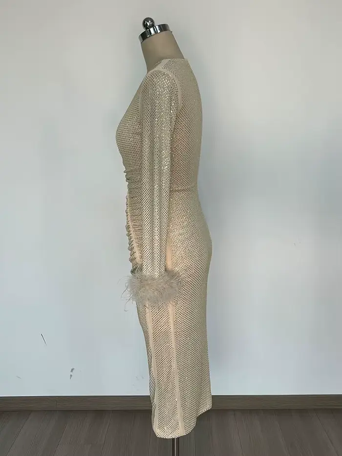 Robe chic à paillettes dorées avec détails de plumes